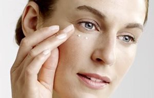 Woman uses eye cream