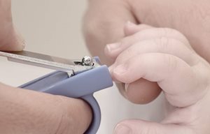 Une mère coupe les ongles d'un bébé avec un coupe-ongle.